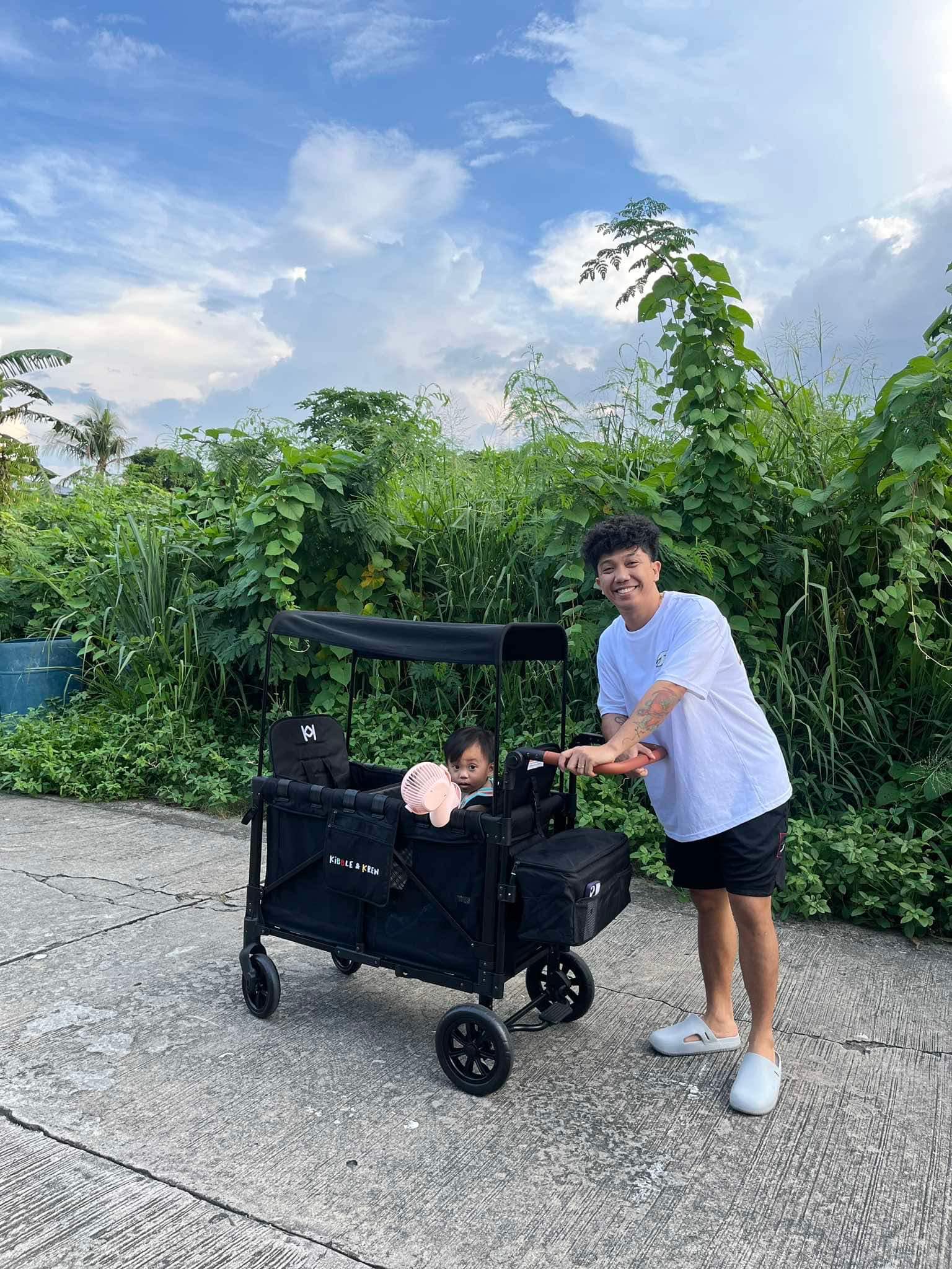 keng with his son inside a kibble and krew stroller wagon